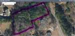 A digital map shows a wooded property outlined in purple along 14 & 15 Dove Road near Oxford in Granville County. Surrounding lots, roads, and some houses are visible with parcel numbers and boundary lines clearly marked.
