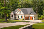 A modern farmhouse at 30 Park Meadow Lane in Youngsville, with white siding, wood accents, and a three-car garage, is surrounded by green grass, tall trees, and a curved driveway on a sunny day.