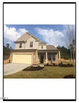 Two-story suburban house at 55 Nobleman Court in Franklinton, featuring beige siding, stone accents, a two-car garage, manicured lawn, and young trees. The sky is partly cloudy with greenery and woods providing a scenic backdrop.