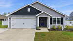 Single-story gray house at 108 Anaheim Street, Oxford, featuring a black gable, white garage door, and purple front door. There's a small covered porch, landscaped front yard, and a concrete driveway under a blue sky.
