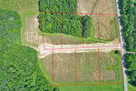 Aerial view of a rural plot on 005 Rock Mill Road, Henderson, divided into five sections by red boundary lines, with trees, grass, and a dirt road running horizontally through the property.