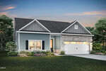 Beautiful single-story modern house at 25 Arch Way, Youngsville, featuring blue siding, stone accents, a white garage door, and a covered front porch; landscaped yard with green grass, shrubs, and trees under a dusk sky.