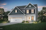 Two-story modern suburban house with dark blue and white siding, double garage, front porch, and landscaped yard located in Youngsville at 45 Arch Way. Evening lighting highlights the windows and entryway, while trees and grass surround the home.