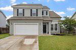 Two-story suburban house with gray siding, black shutters, a double garage, and a small covered entryway located at 41 Duchess Avenue in Franklinton. The front lawn is neatly trimmed, and a concrete driveway leads up to the garage and main entrance.