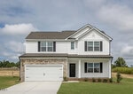 Two-story suburban house with white siding, black shutters, a double garage, brick accents, and a small front lawn located at 40 Arch Way in Youngsville. The sky is partly cloudy, and the house is surrounded by undeveloped land.