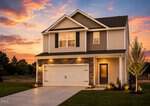 Two-story modern suburban house with a gray roof, stone and siding exterior, two-car garage, front door with window, manicured lawn, and young tree, pictured at sunset with outdoor lights turned on. Located at 55 Arch Way in the heart of Youngsville.