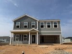 This two-story gray house at 20 Silverbell Court in Youngsville is under construction, featuring four windows upstairs, three windows and a covered porch downstairs, and an open two-car garage. The yard is bare dirt with no landscaping yet.