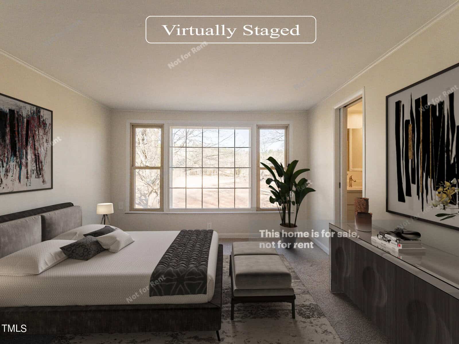 A virtually staged bedroom with a large bed, a bench at the foot, and a rug on the floor. A large window lets in natural light. Decor includes abstract paintings and a potted plant. Text indicates the home is for sale, not for rent.