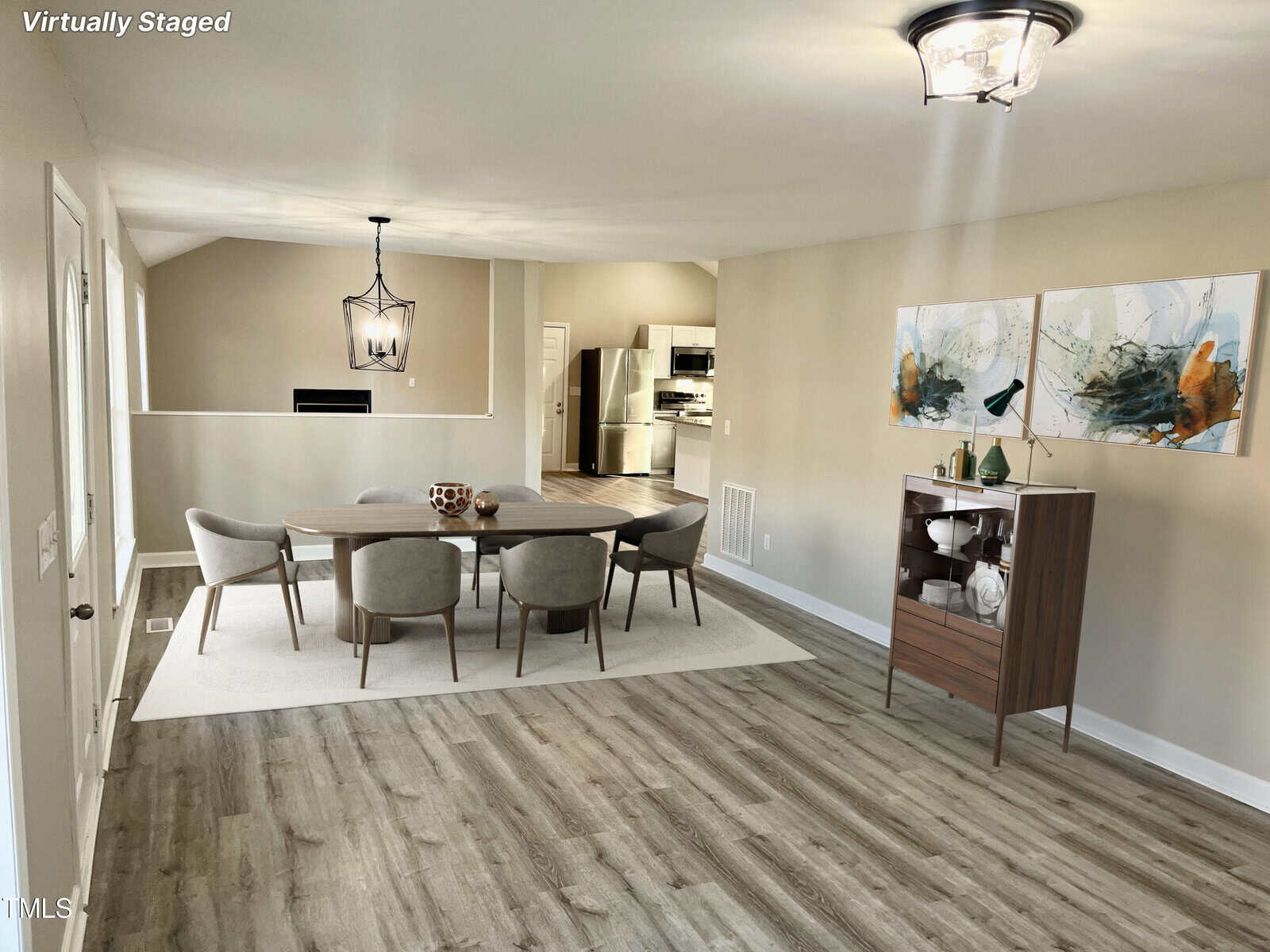 A spacious, virtually staged dining area with contemporary furnishings, including a sleek dining table set, a wooden cabinet, and large abstract wall art, complemented by modern lighting fixtures and wood-style flooring.