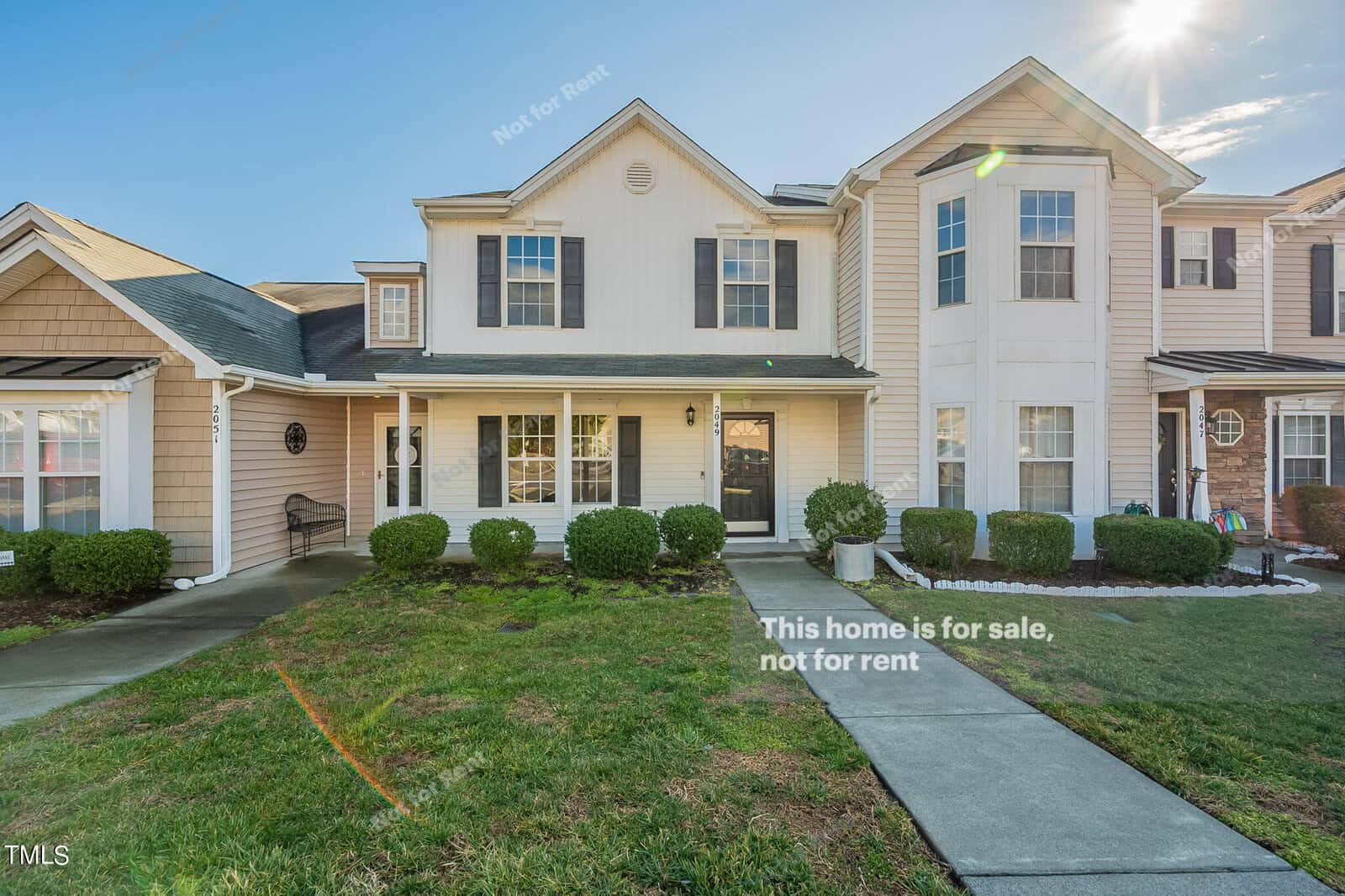 Front view of a two-story house at 2049 Quail Circle, Creedmoor, with a well-maintained lawn and shrubs. The house features large windows and a prominent central gable. Text on the image states, "This home is for sale, not for rent.