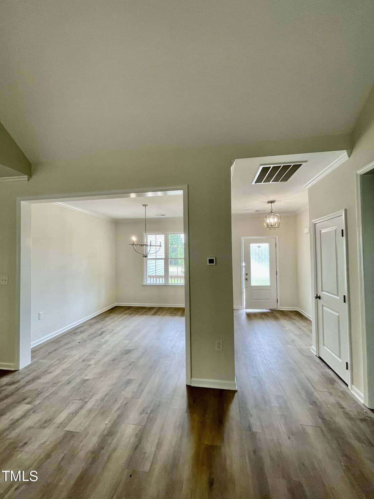 A room with wood flooring and white walls.