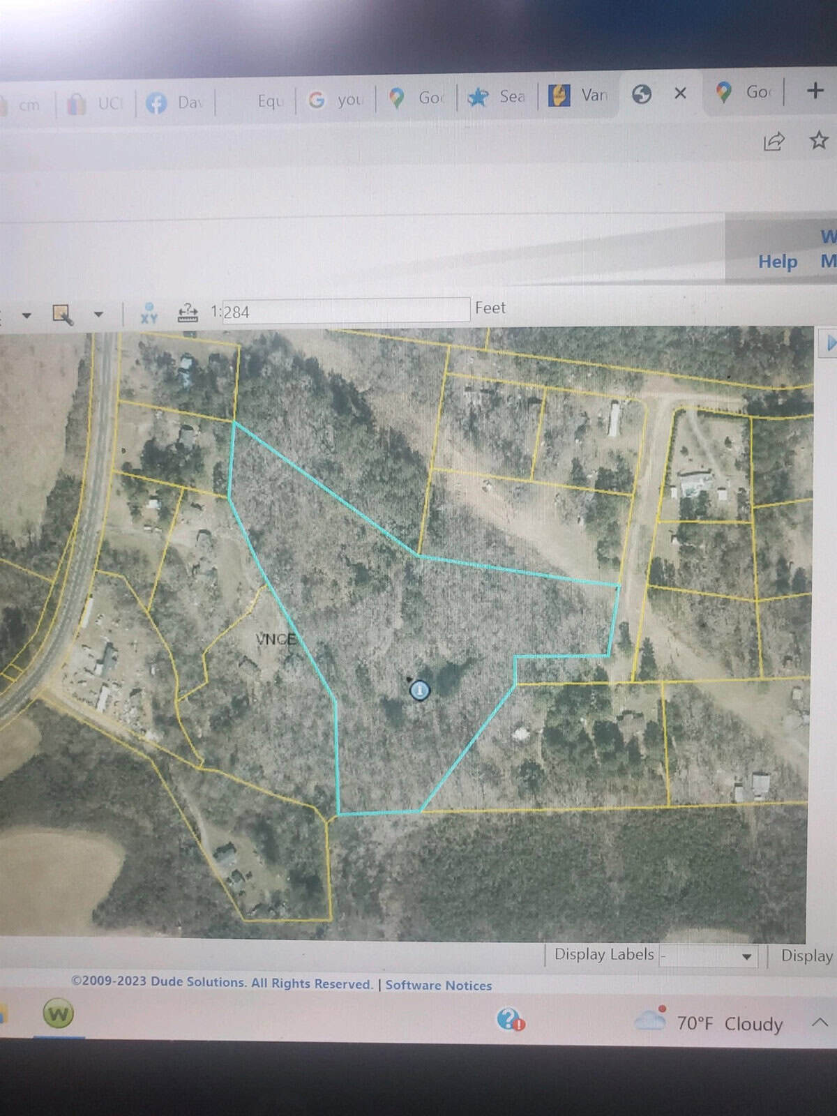 Aerial view of Henderson NC, with delineated parcels marked by blue and yellow lines on a mapping software interface, displaying various plots and roads at 0 L & S Lane.