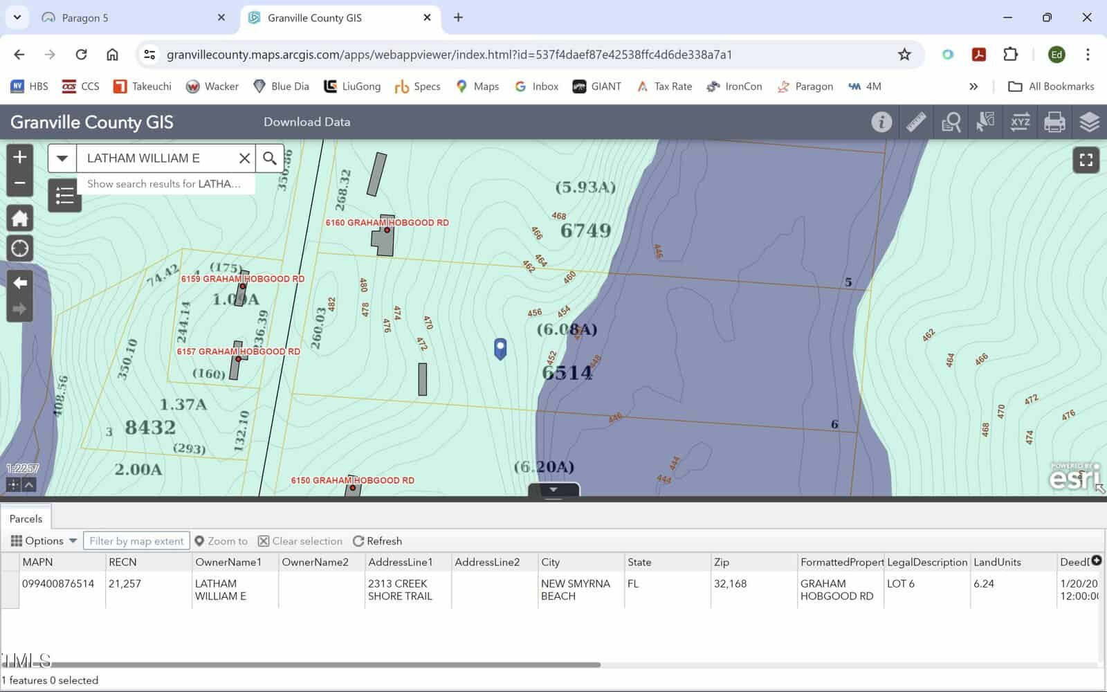 Screenshot of a GIS map showing property and parcel information near a body of water. Parcels with IDs and owner names are visible. Contour lines indicate elevation. The interface displays data like owner, location, and zoning information in a table below.