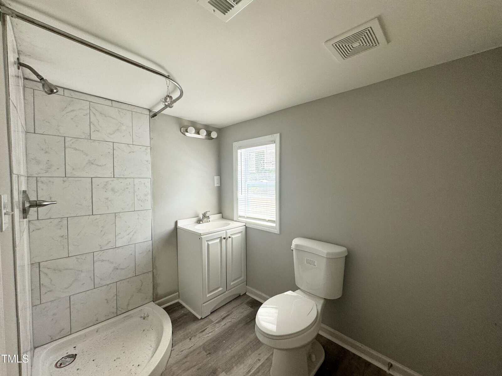 A bathroom with a toilet and sink.
