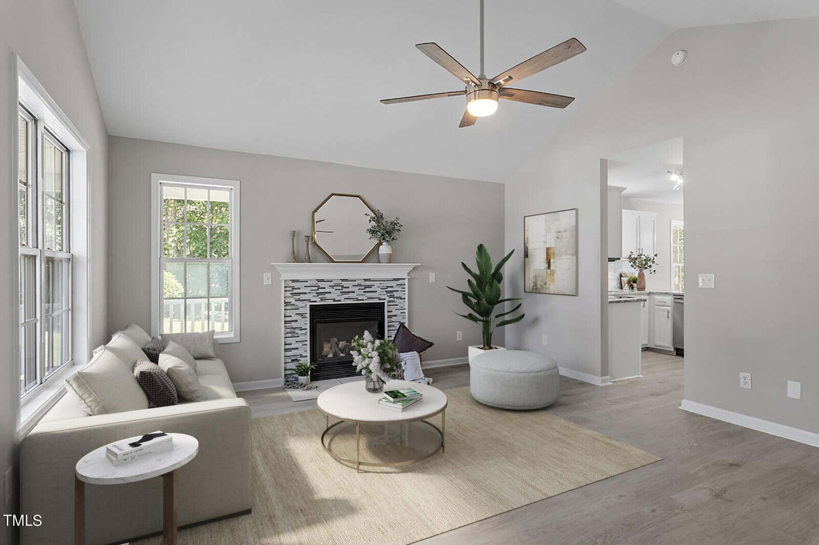 Located at 106 Green Tree Circle, this modern living room in Oxford features a beige sofa, wooden coffee table, and a cozy fireplace. A large window lets natural light flood the space, while a ceiling fan adds elegance to the high ceiling. Plants and decorative items complete the mantel and side table.
