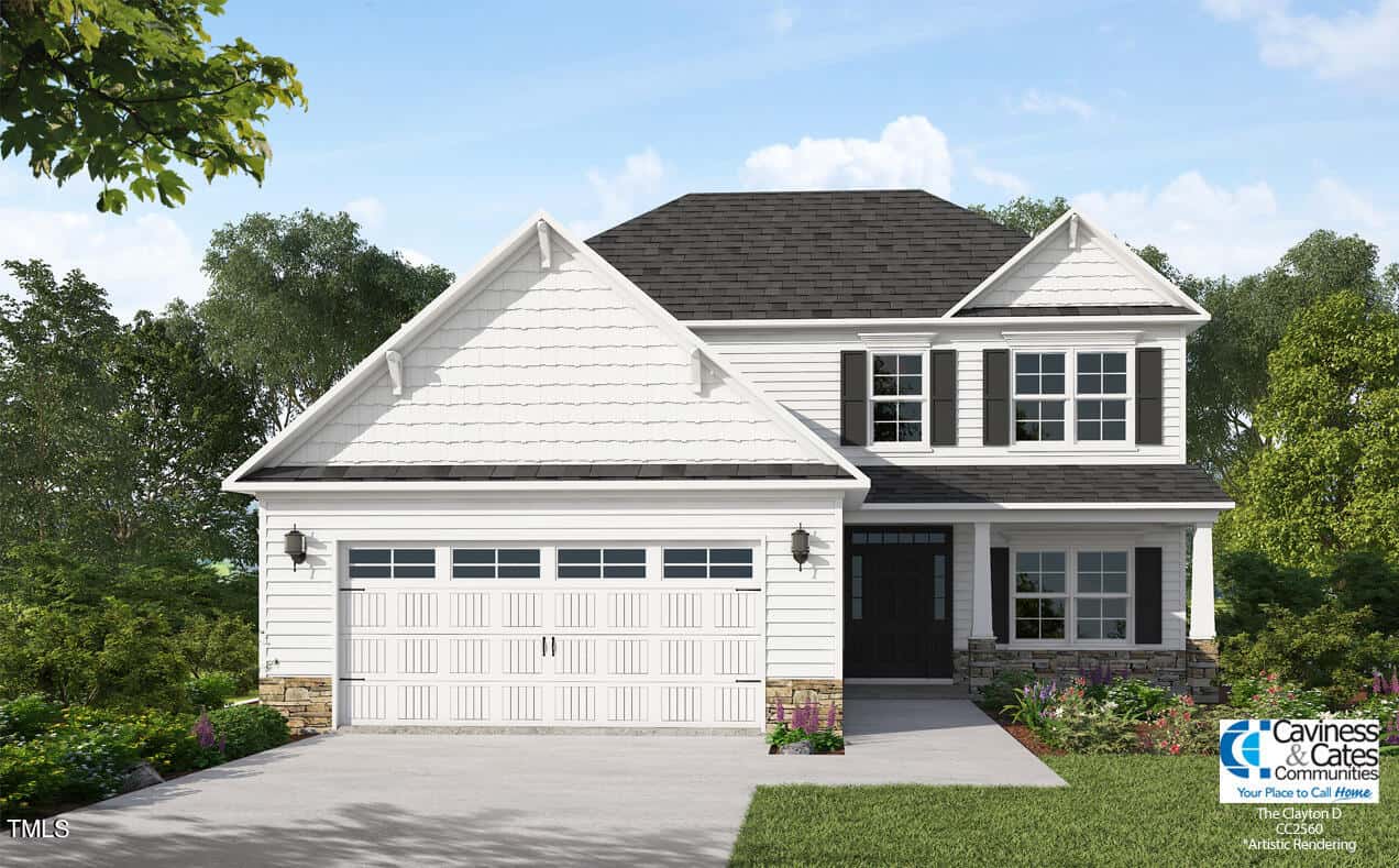 A modern two-story white house with black shutters, a gray shingled roof, and a double garage. The yard features green grass, bushes, and trees. The Caviness & Cates Communities logo is visible in the bottom right corner.