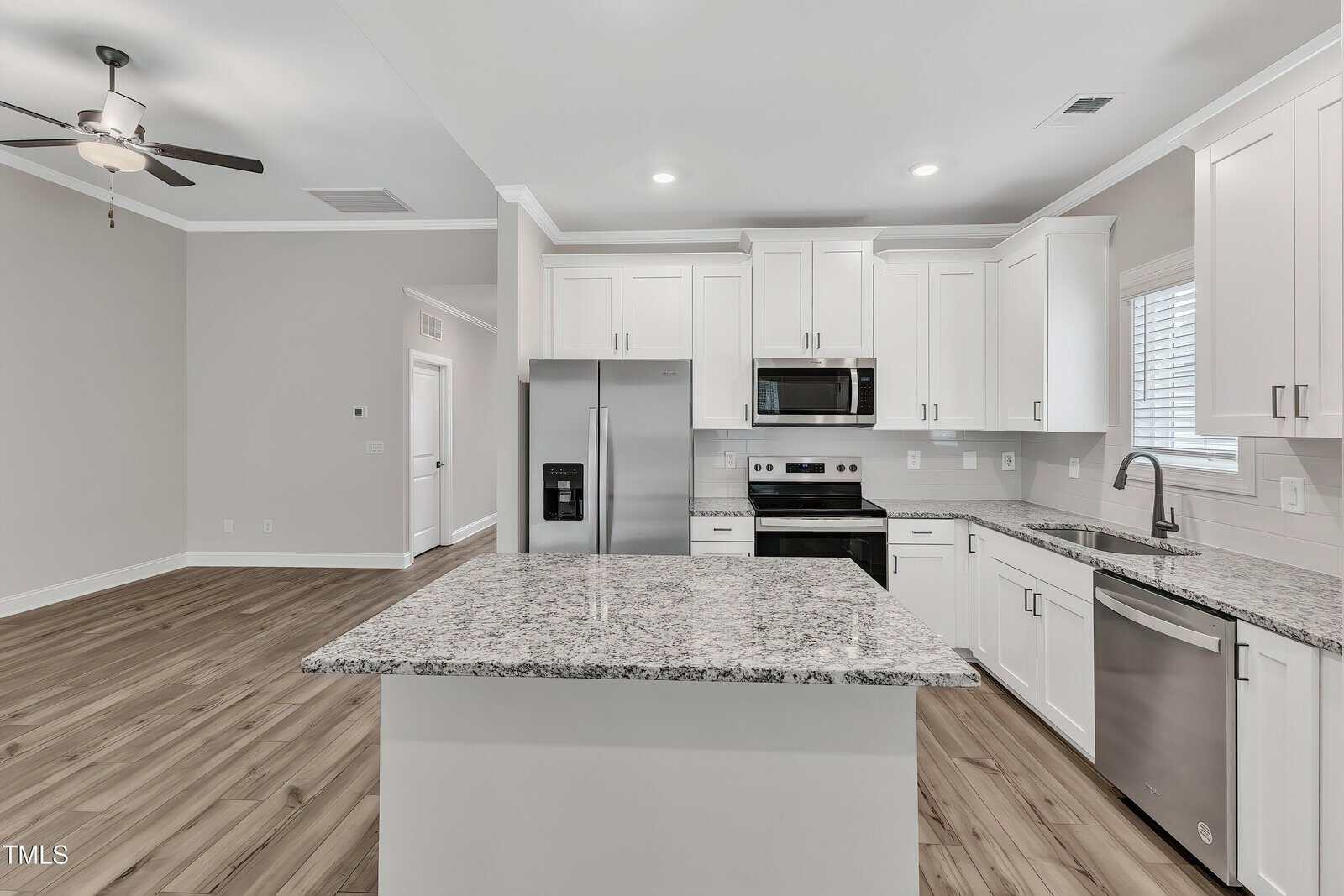 A kitchen with a marble countertop.