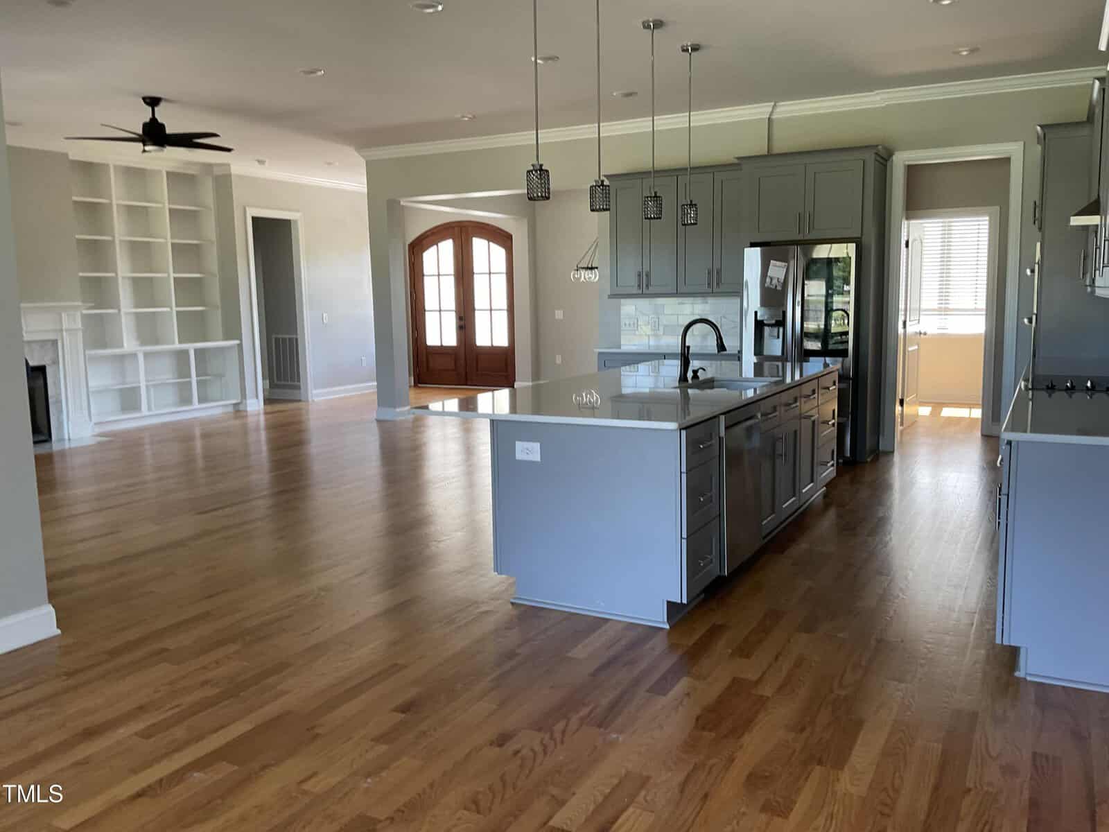 A kitchen and dining room with hardwood floors.