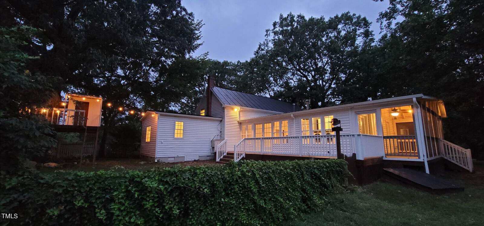 Cute wooded country home with an expansive wraparound porch.