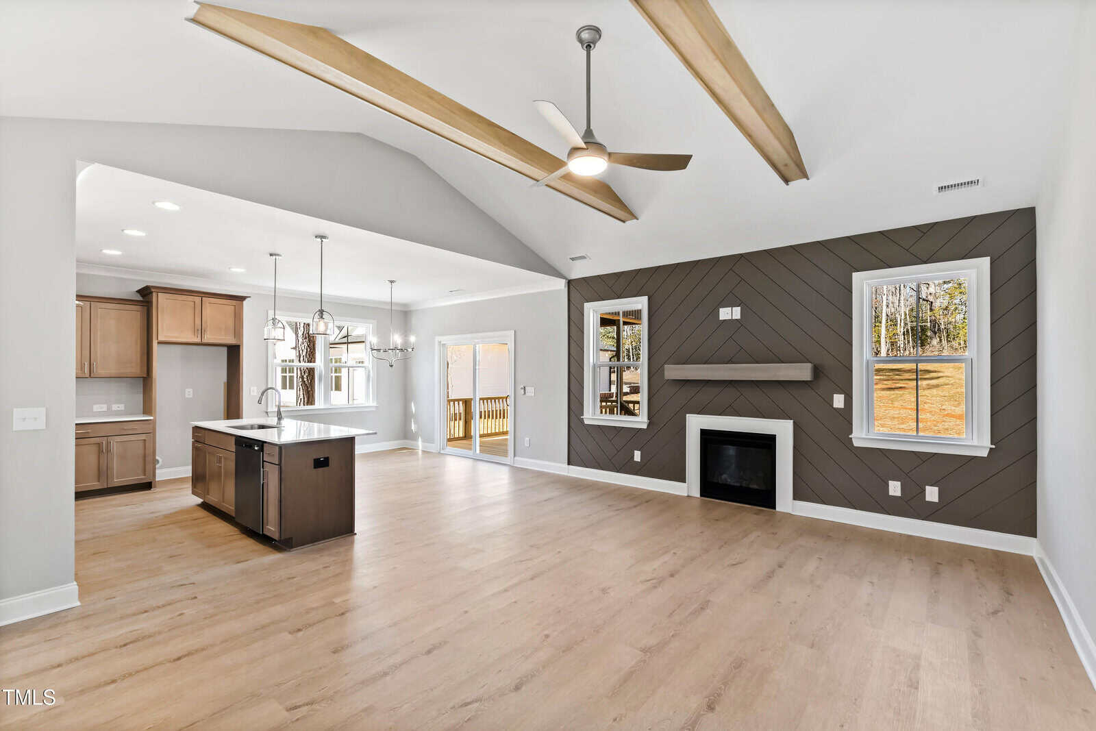 A large open floor plan with a kitchen and a fireplace.