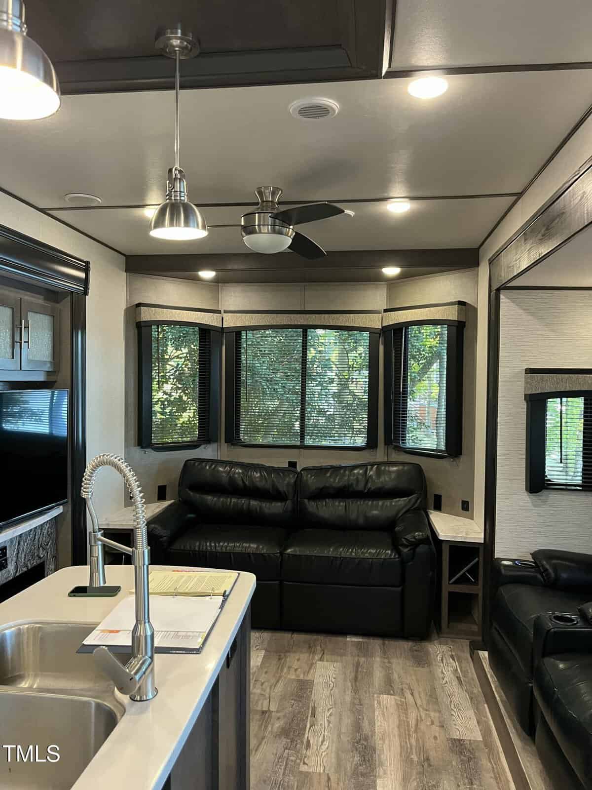 A living room with a sink and a couch.