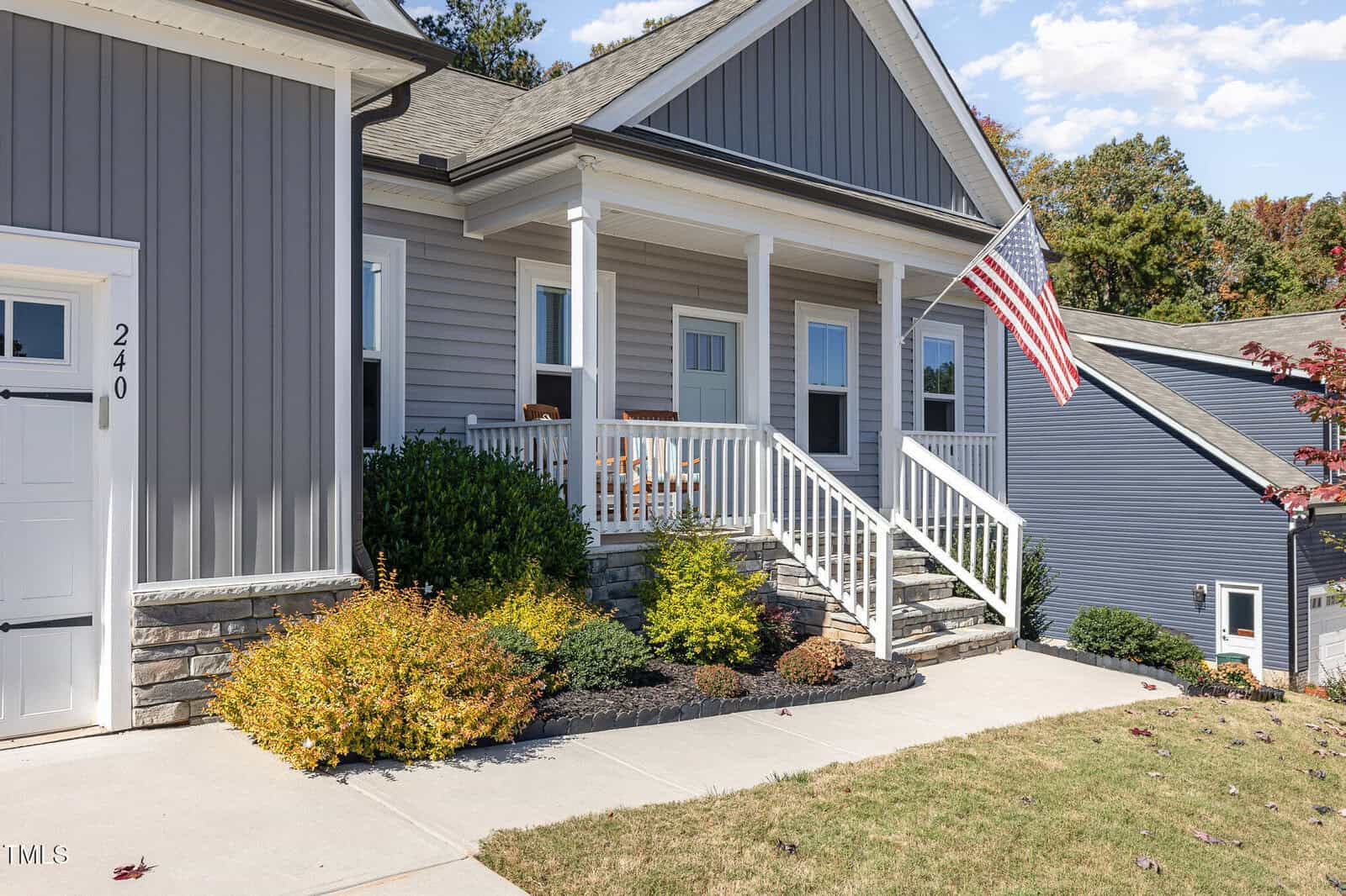 A house with a flag on the front porch.