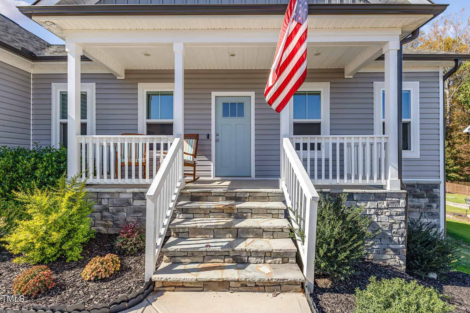 A house with a flag on the front porch.