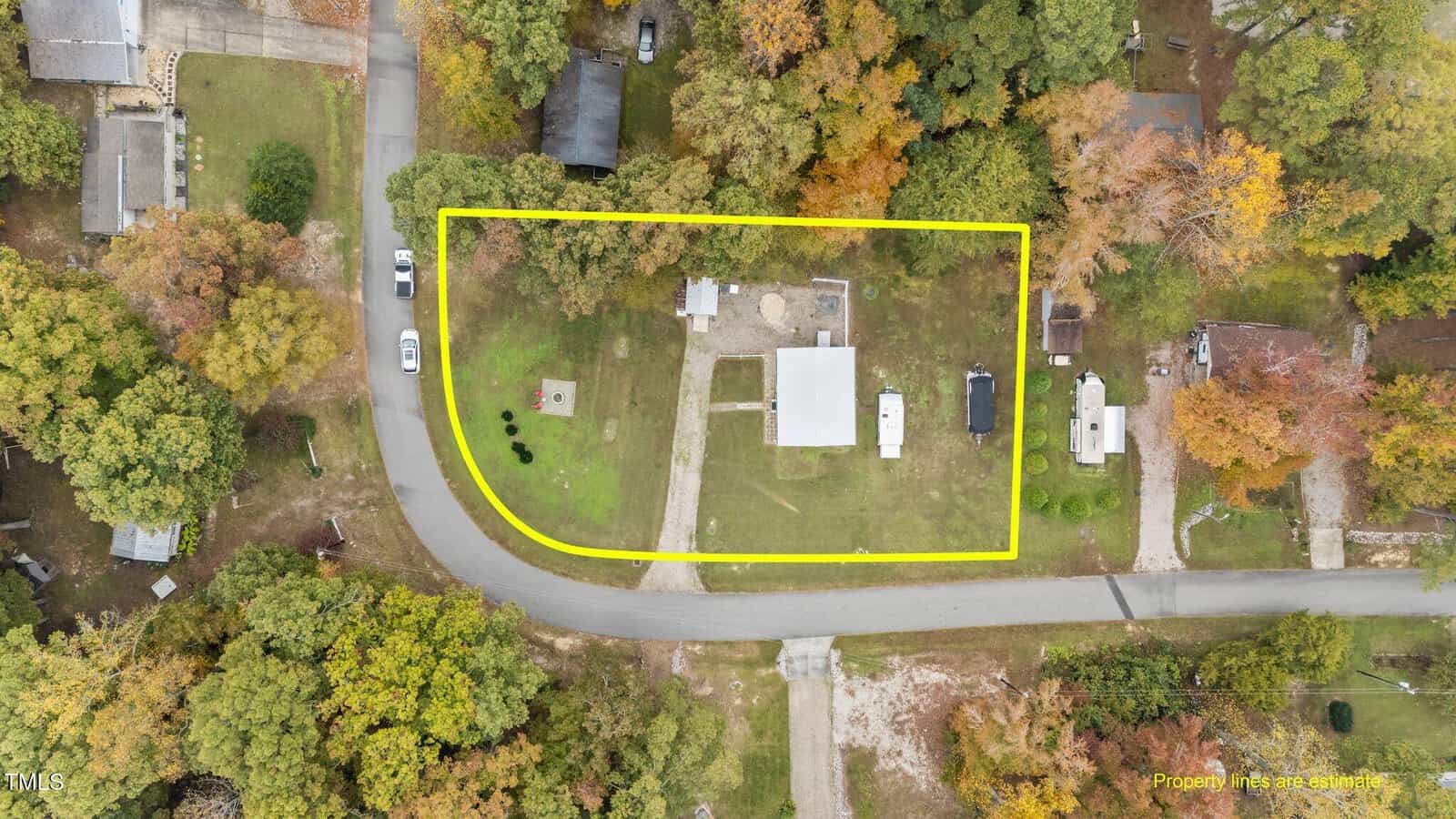 Aerial view of a road and a yard with a yellow line.