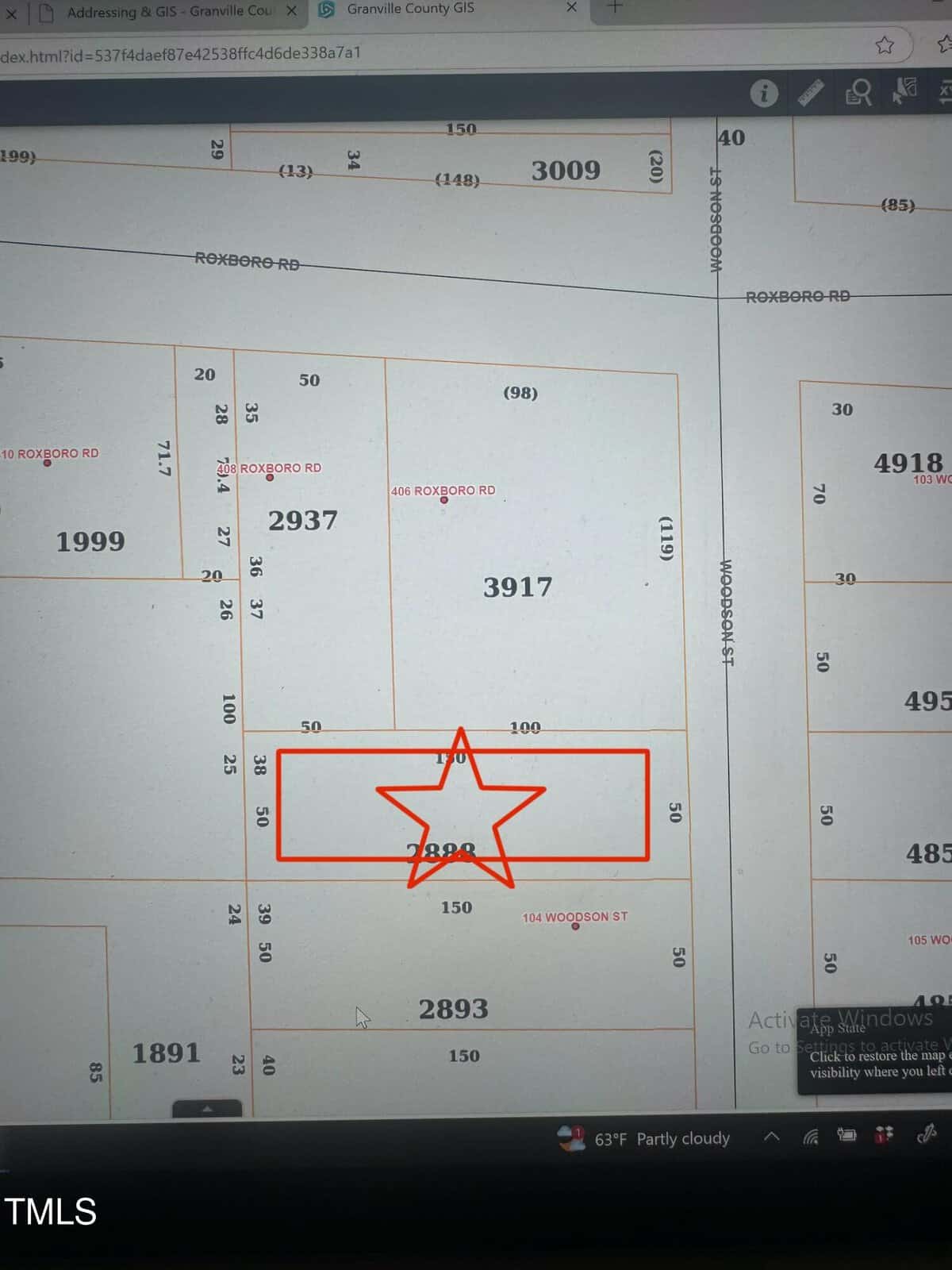 A computer screen displays a GIS map showing parcels of land with labeled plot numbers. One plot, numbered 3890, is highlighted with a red outline and star. Other plot numbers, roads, and boundaries are visible around it.