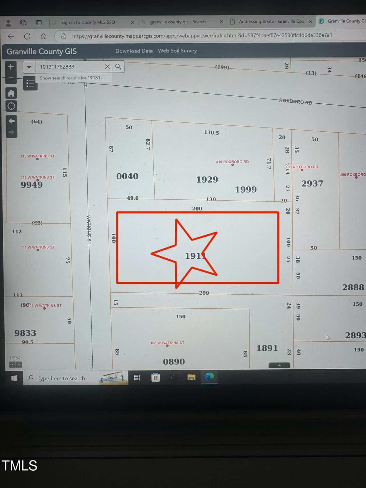 A computer screen displaying a Granville County GIS map. The map shows numbered plots of land with one plot, labeled 1911, outlined in red with a red star. Various lot numbers and road details are visible surrounding the highlighted plot.