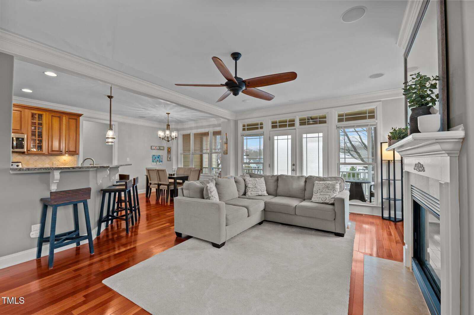 A living room with a couch and a kitchen.