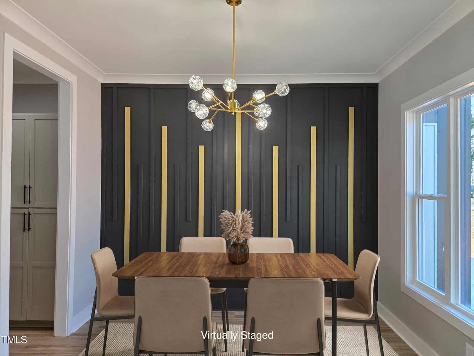 Modern dining room with a wooden table, four beige chairs, a geometric gold chandelier, and a black accent wall with vertical gold lines. A window is on the right, and “Virtually Staged” text appears at the bottom.