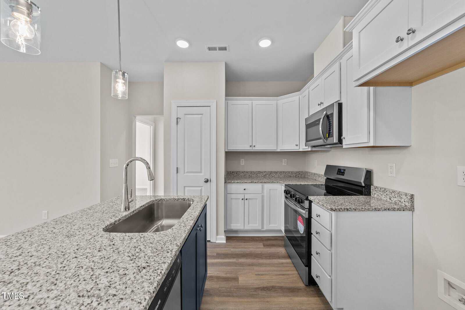 A kitchen with granite counter tops and a sink.