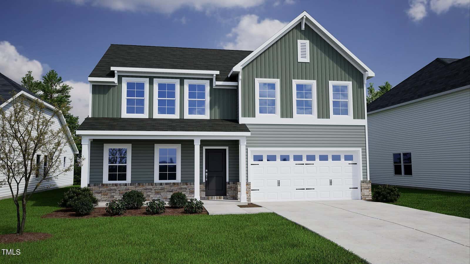 A two-story suburban house with green vertical siding, white trim, black roof, and a two-car garage. There are shrubs and a small tree in the front yard, with a concrete driveway and walkway.