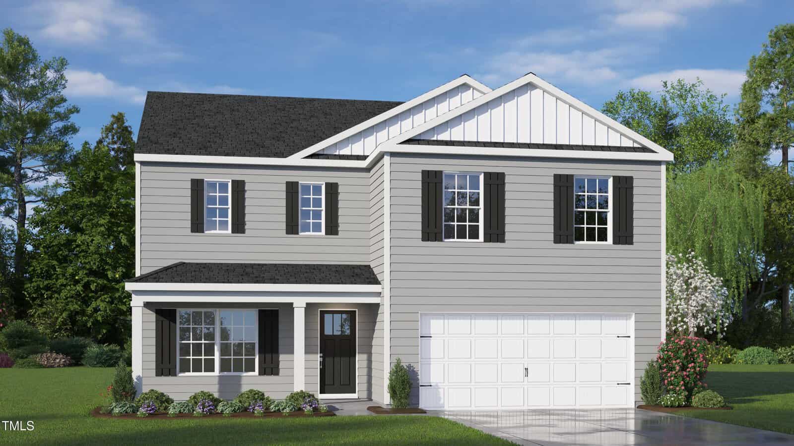 A two-story gray house with white trim, black shutters, and a front porch sits on a green lawn with shrubs and flowers, a double garage, and trees in the background under a blue sky.