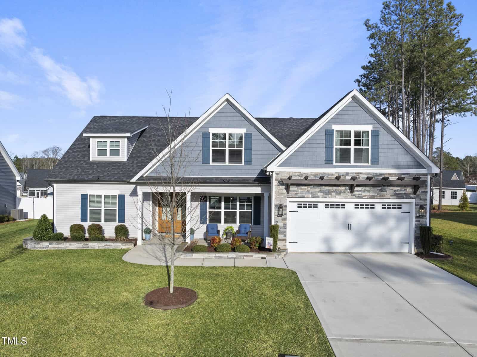 A house with a driveway and lawn.