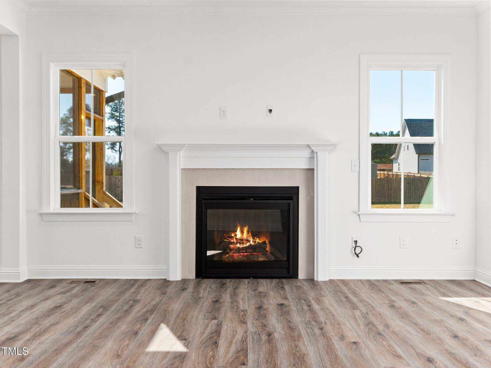 A fireplace in a room with windows.