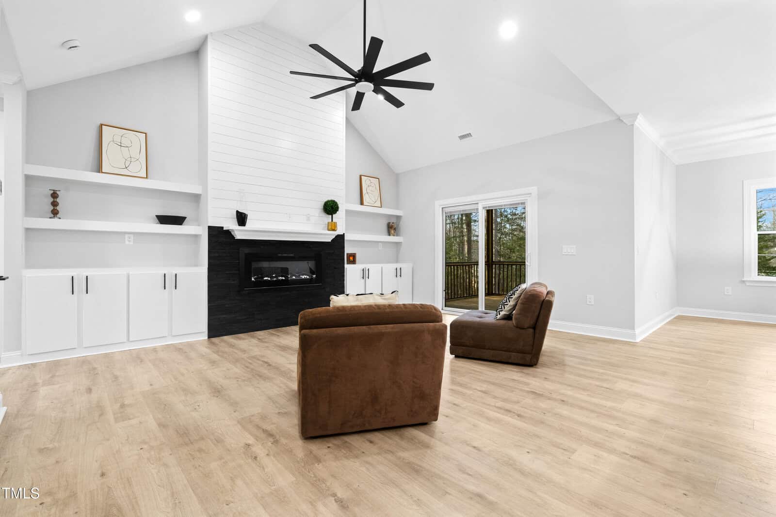 A living room with a fireplace and chairs.