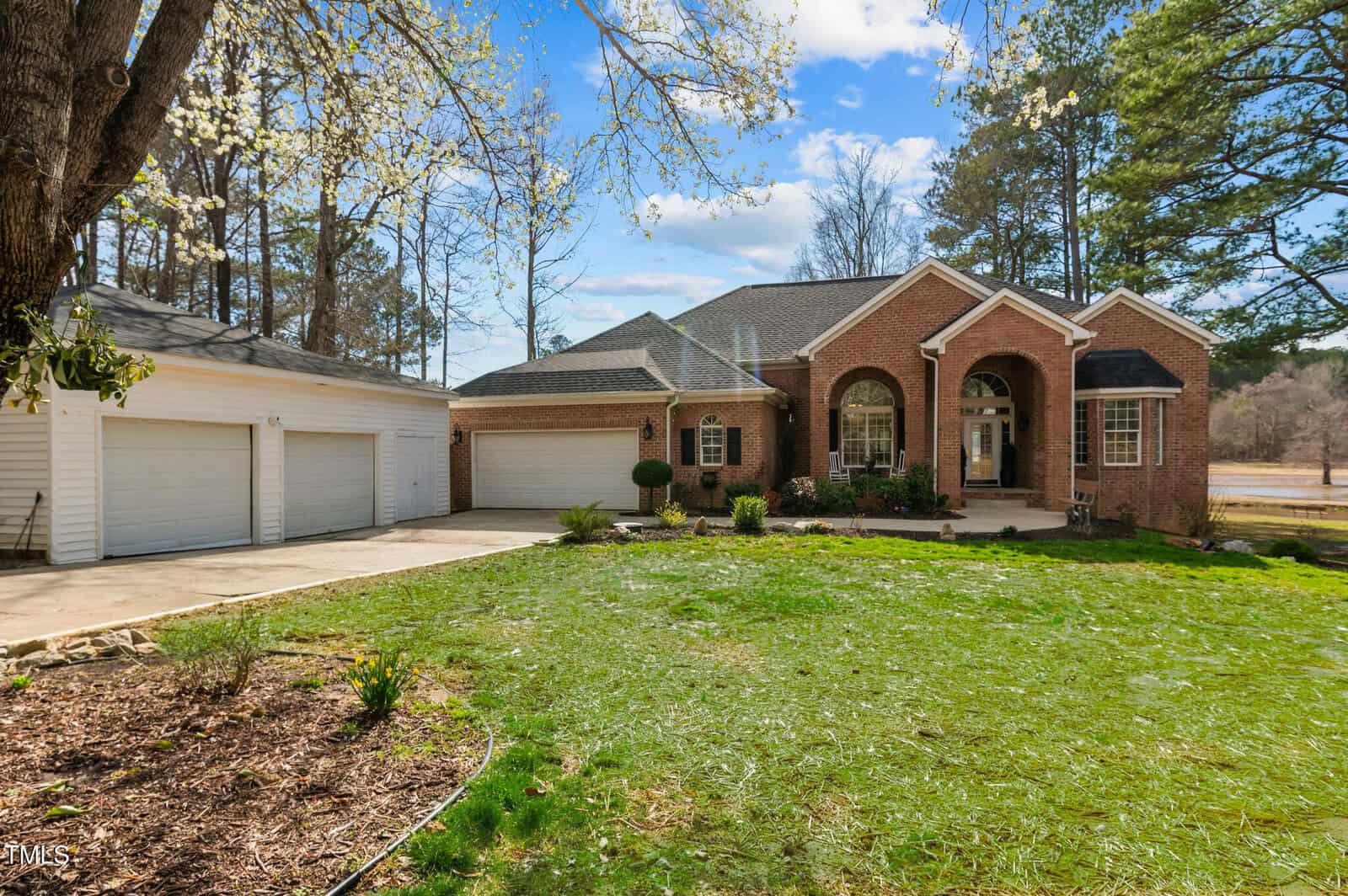 A house with a lawn and a driveway.