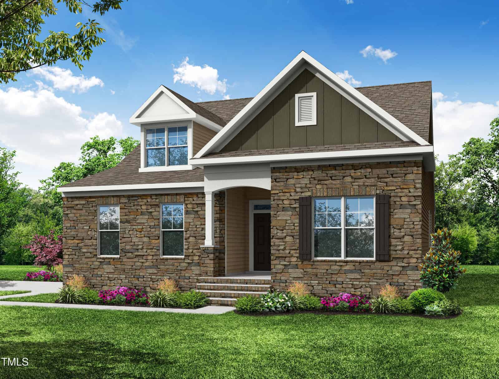 A two-story house with stone and siding exterior, gabled roof, white trim, and a sheltered front entrance. The yard is landscaped with green grass, shrubs, and colorful flowers under a sunny sky.