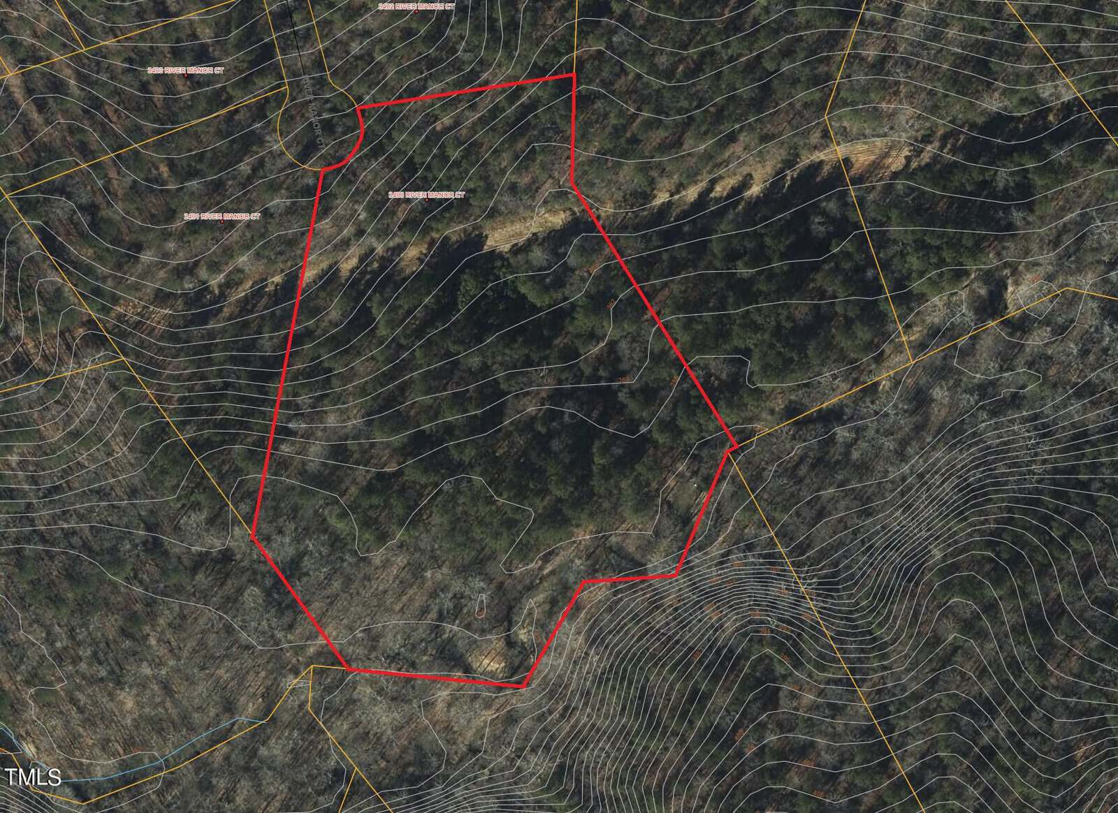 A topographic map showing a wooded area with contour lines illustrating elevation changes. A red boundary outlines a specific section within the map, indicating a distinct region of interest.
