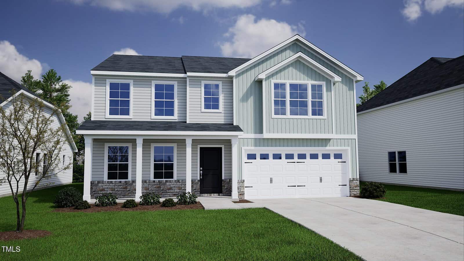A two-story suburban house with light blue siding, brick accents, and a double garage. The front yard is landscaped with grass, small bushes, and a young tree. The sky is partly cloudy.