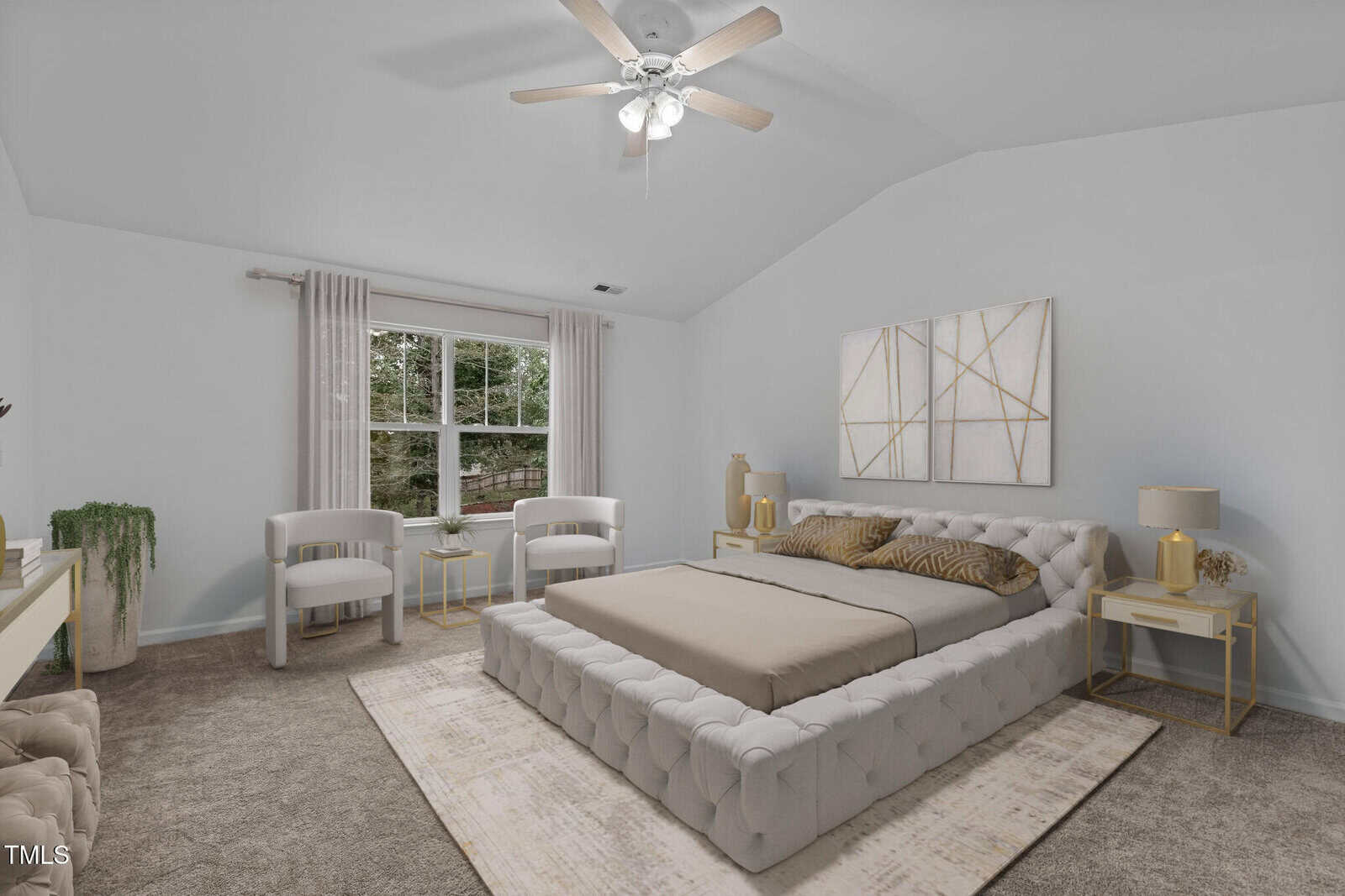 A bedroom with a large bed featuring a tufted headboard and beige bedding. Two white chairs and a small table are near a window with curtains. Matching lamps sit on bedside tables. Neutral tones and minimalist decor are used throughout.