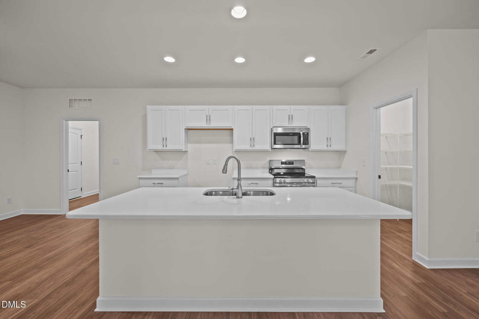 A kitchen with a white island.