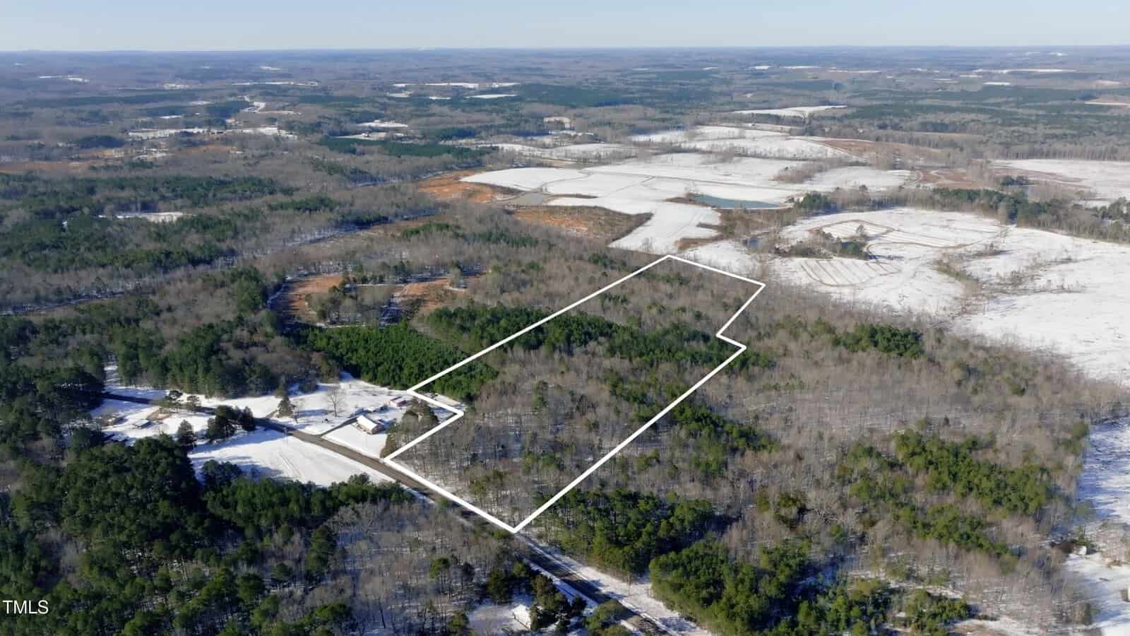 Aerial view of a rural, snow-dusted landscape near 9035 Robert Morgan Road, Oxford, with a rectangular section of wooded land outlined in white, showing surrounding trees, fields, and a few scattered buildings.