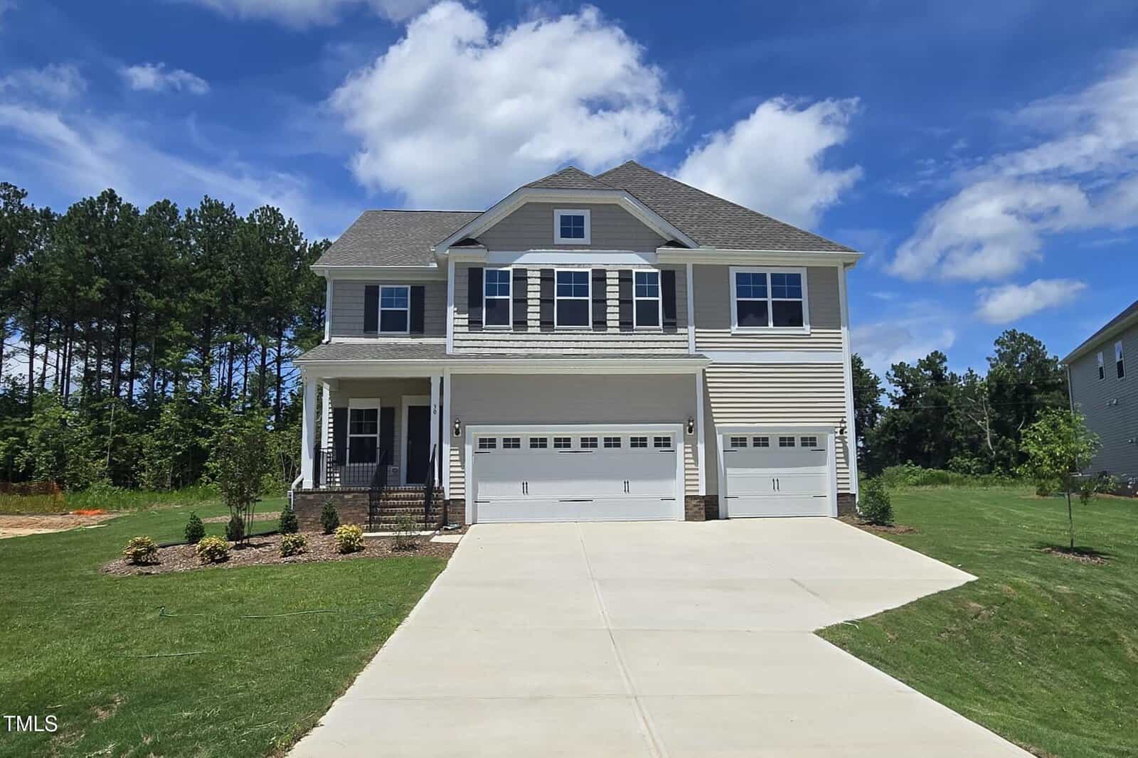 A house with a driveway and grass.