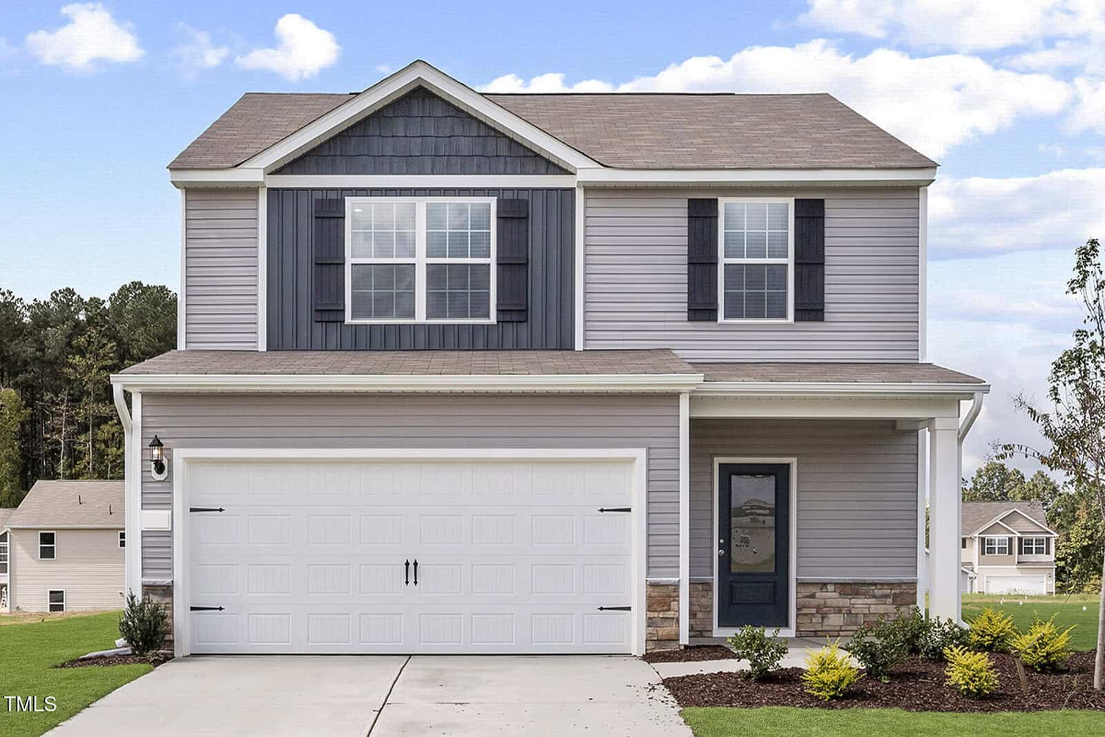 Two-story suburban house at 507 Benton Drive, Oxford, with light gray siding, dark gray accents, and white trim. Features a double garage, covered entryway with single door, driveway, and a front yard with lawn and small shrubs.