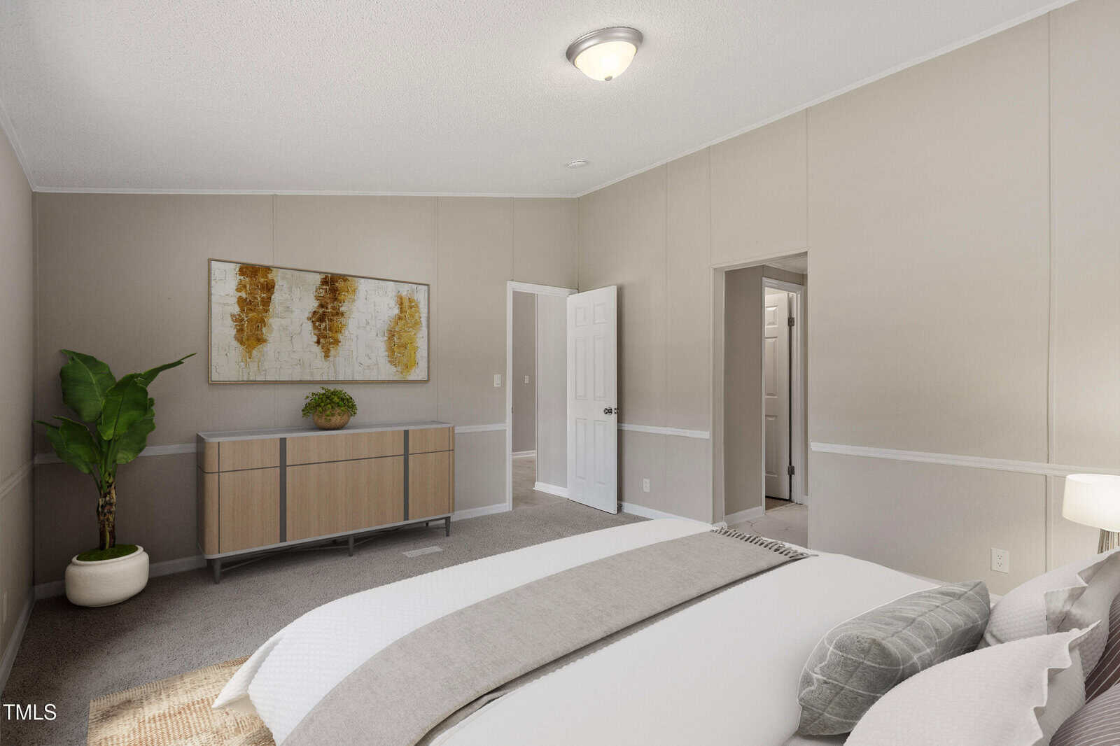 Neutral-colored bedroom with a bed in the foreground, a sideboard against the far wall, a potted plant to the left, abstract wall art above the sideboard, and two open doors leading to adjoining rooms.