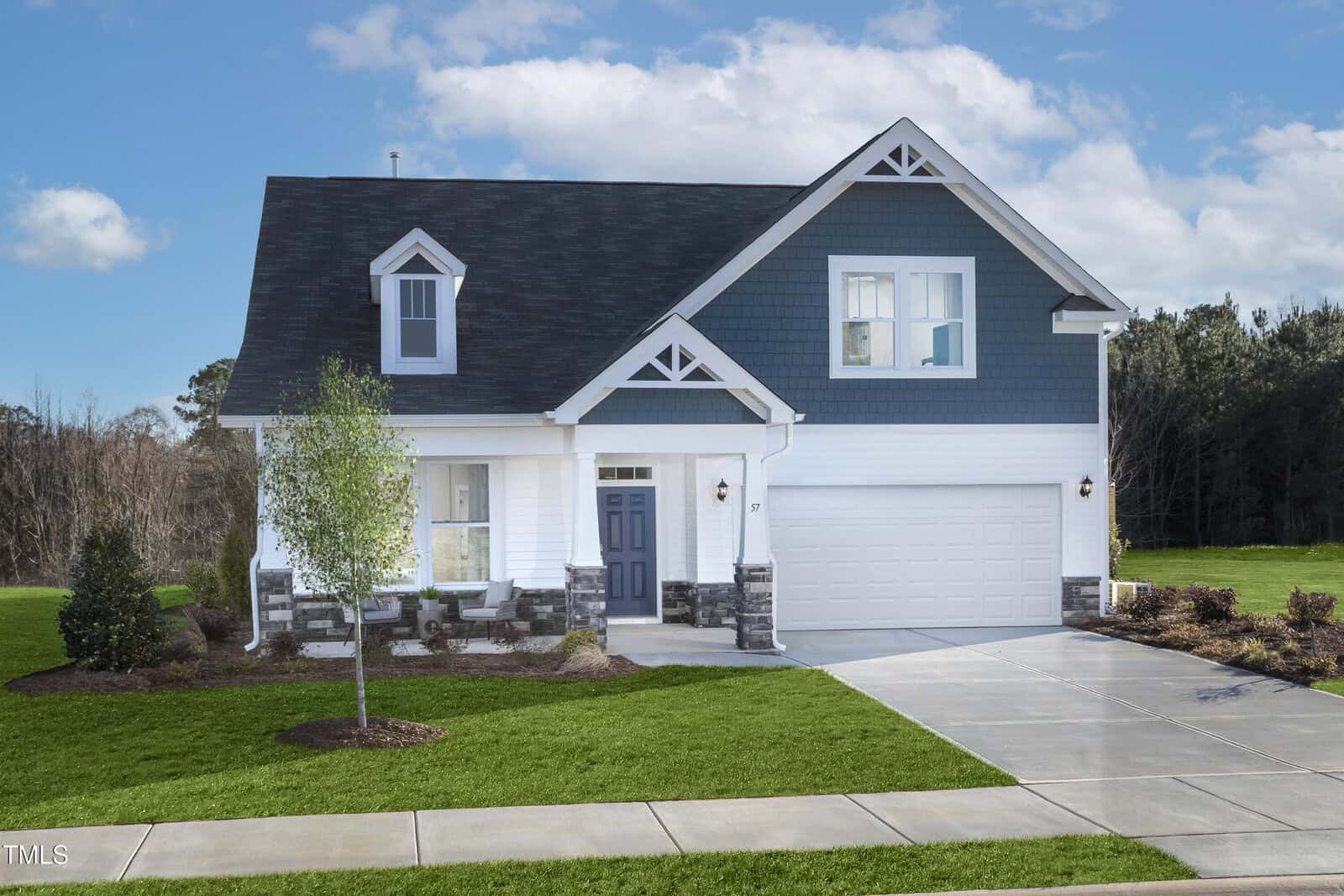 A two-story suburban house in Franklinton with dark blue and white siding, a gray shingled roof, a double garage, a covered porch, and a well-kept lawn with a small tree and shrubs in front. Located at 170 Sugar Pine Drive.