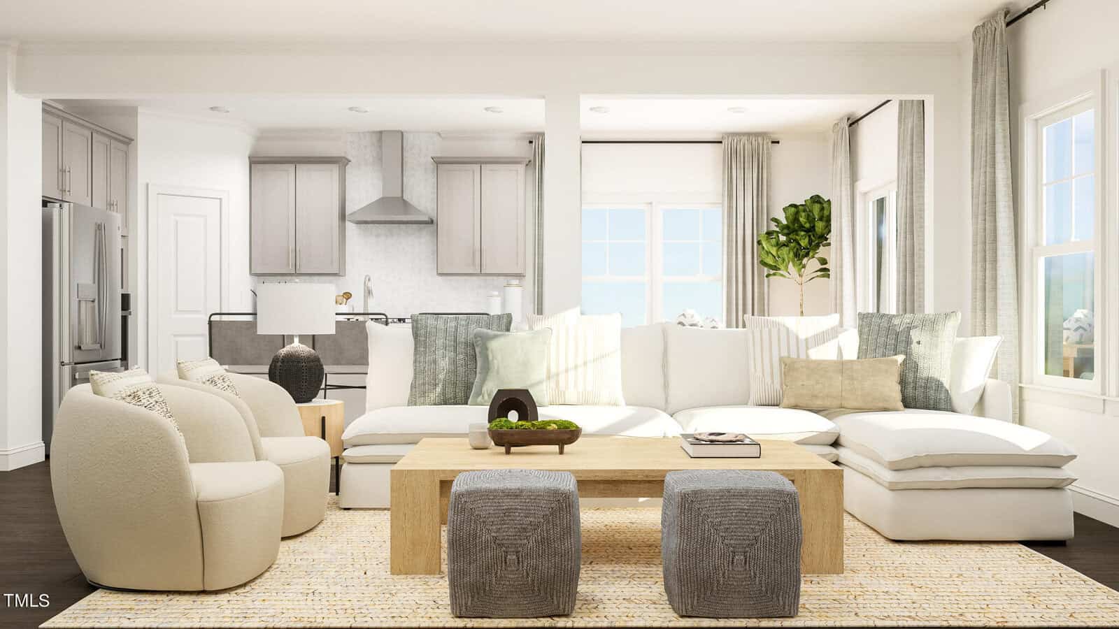 A modern living room with a large sectional sofa, two round chairs, a wooden coffee table, two gray ottomans, and a neutral rug. The open kitchen is visible in the background with white cabinets and stainless steel appliances.